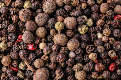 Pepper grains mix as background, top view