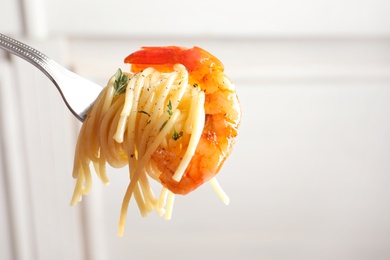 Photo of Eating of delicious pasta with shrimp, closeup