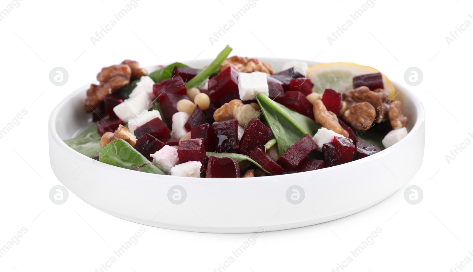 Photo of Delicious beet salad with feta cheese and walnuts in bowl isolated on white