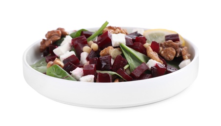 Photo of Delicious beet salad with feta cheese and walnuts in bowl isolated on white