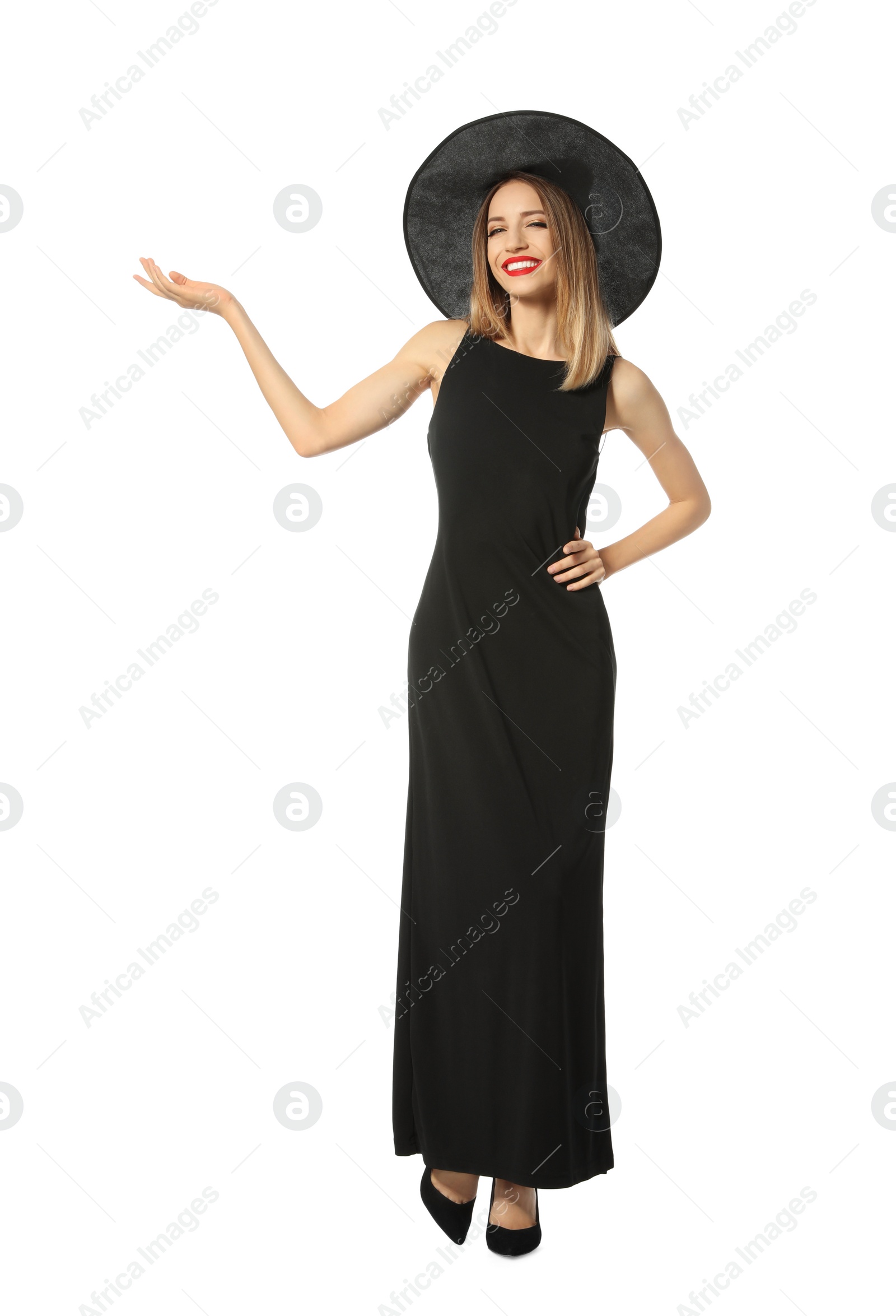 Photo of Beautiful young woman wearing witch costume for Halloween party on white background