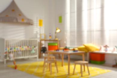 Blurred view of cozy baby room interior