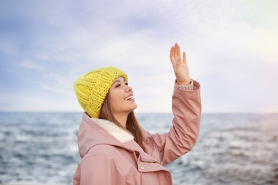 Portrait of beautiful young woman near sea