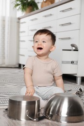 Photo of Cute little boy with cookware at home