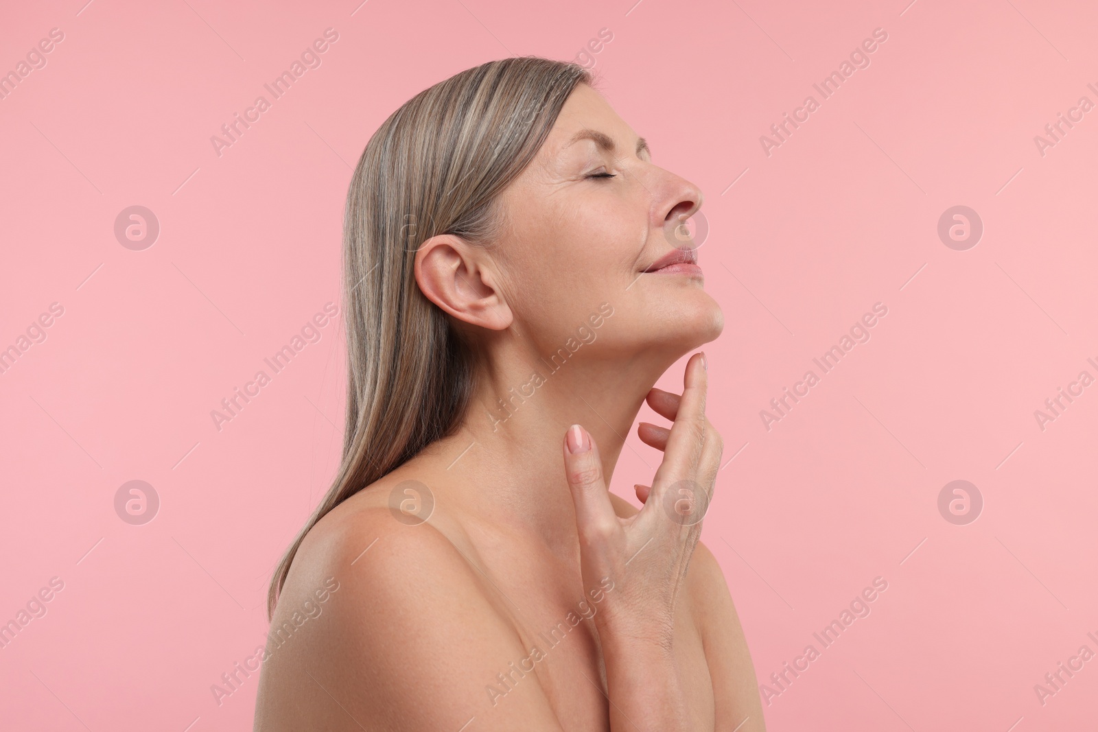 Photo of Beautiful woman with healthy skin on pink background