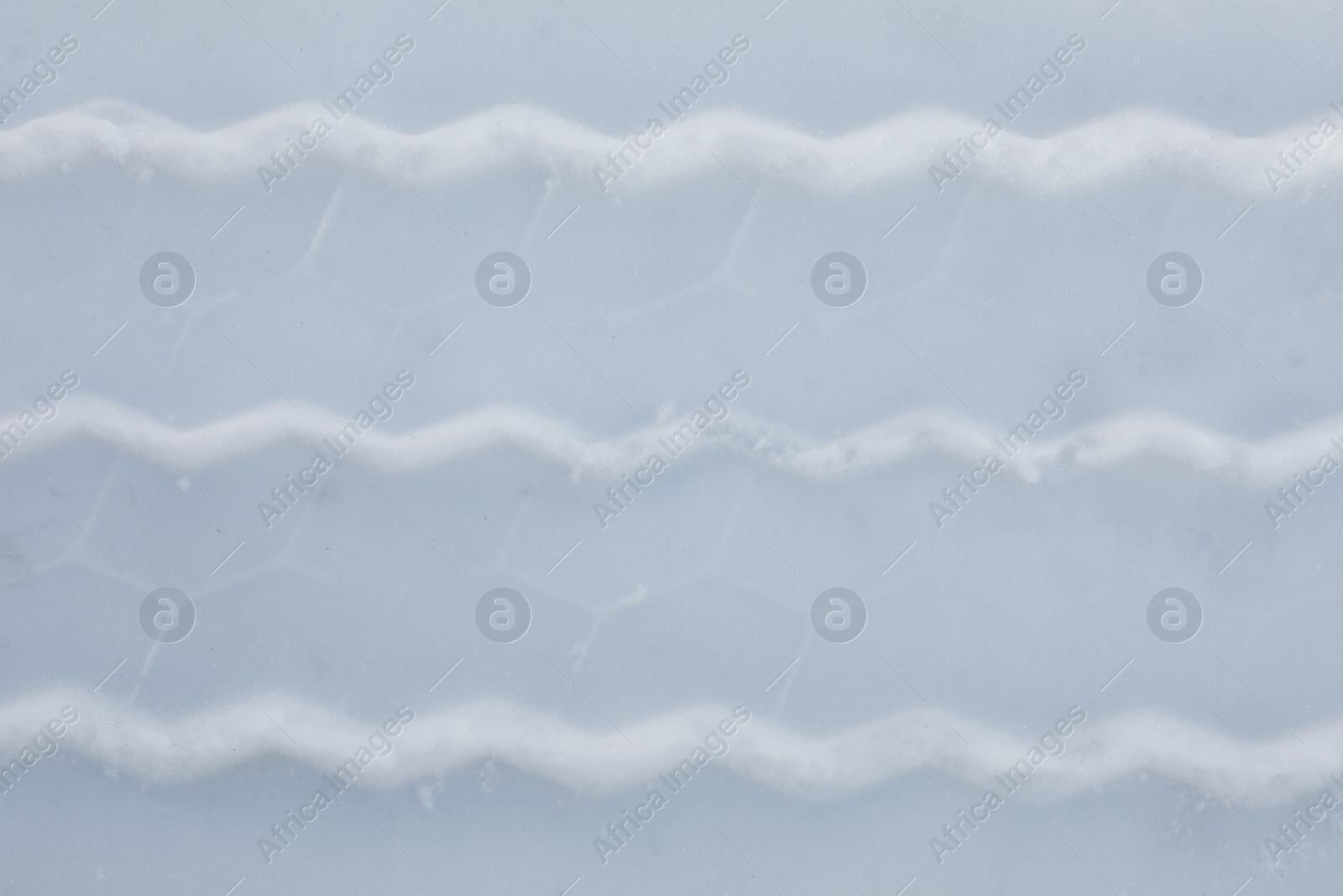 Photo of Car tire track on snow outdoors, top view. Winter season