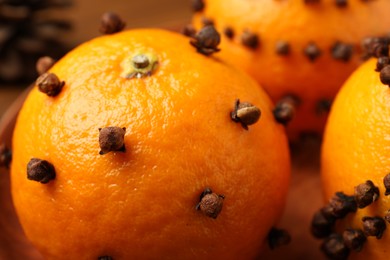 Pomander balls made of tangerines with cloves, closeup