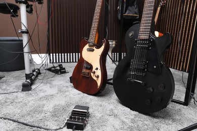 Photo of Electric guitars and pedal at recording studio. Music band practice