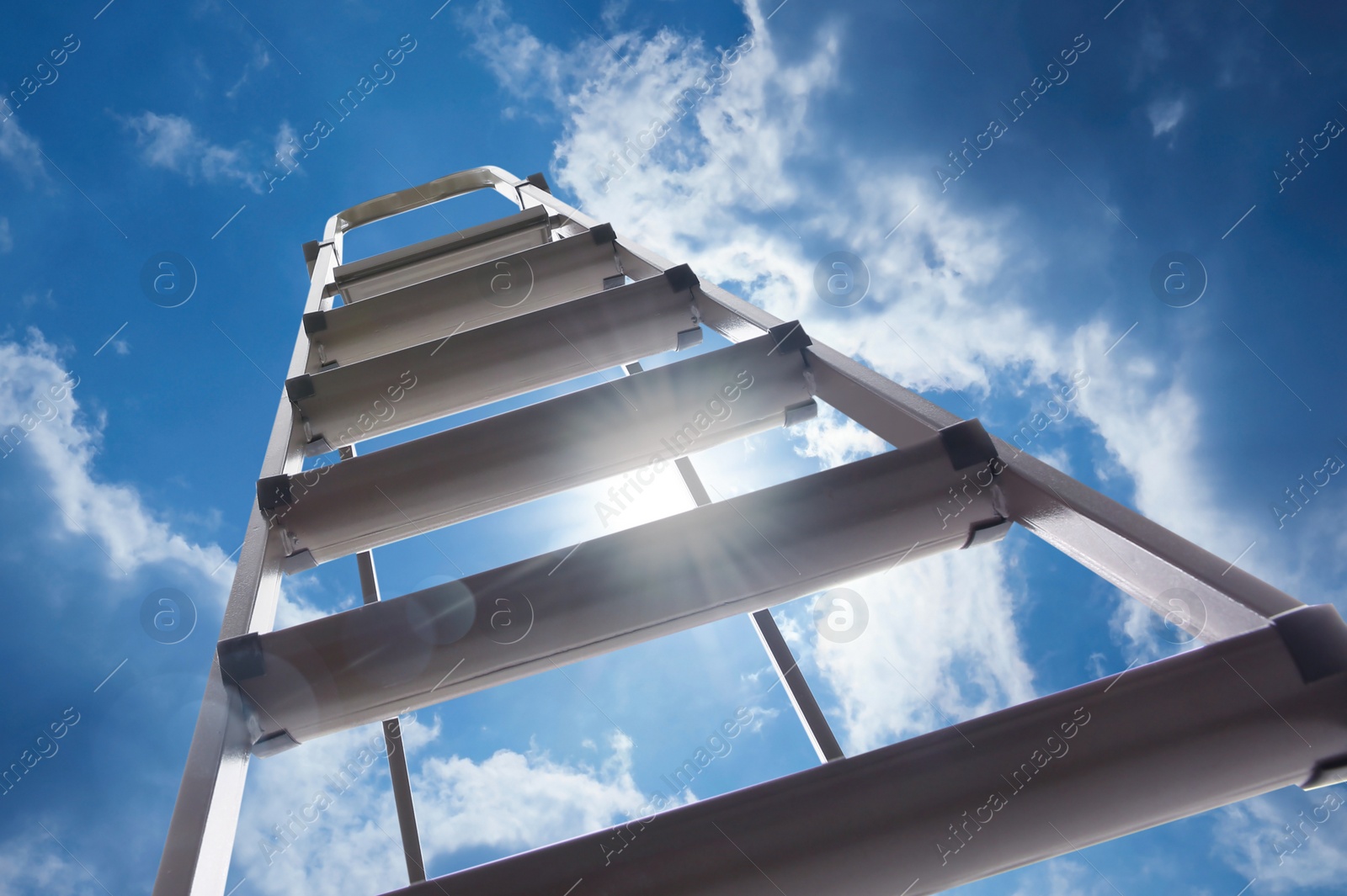 Image of Metal stepladder against blue sky with clouds, low angle view