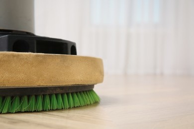 Photo of Modern polishing machine on parquet floor indoors, closeup. Space for text