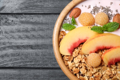 Photo of Healthy homemade granola with yogurt on grey wooden table, top view. Space for text