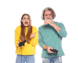 Mature man and young woman playing video games with controllers isolated on white
