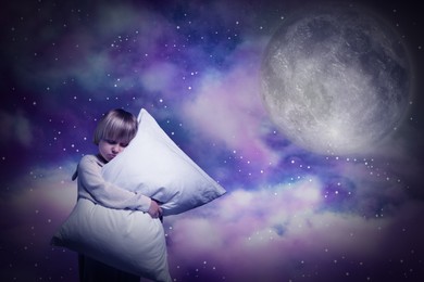 Image of Boy sleepwalker hugging pillow in clouds in starry sky with full moon
