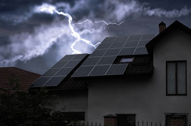Image of Dark cloudy sky with lightning over house. Stormy weather