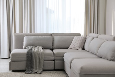 Large grey sofa in living room. Interior design