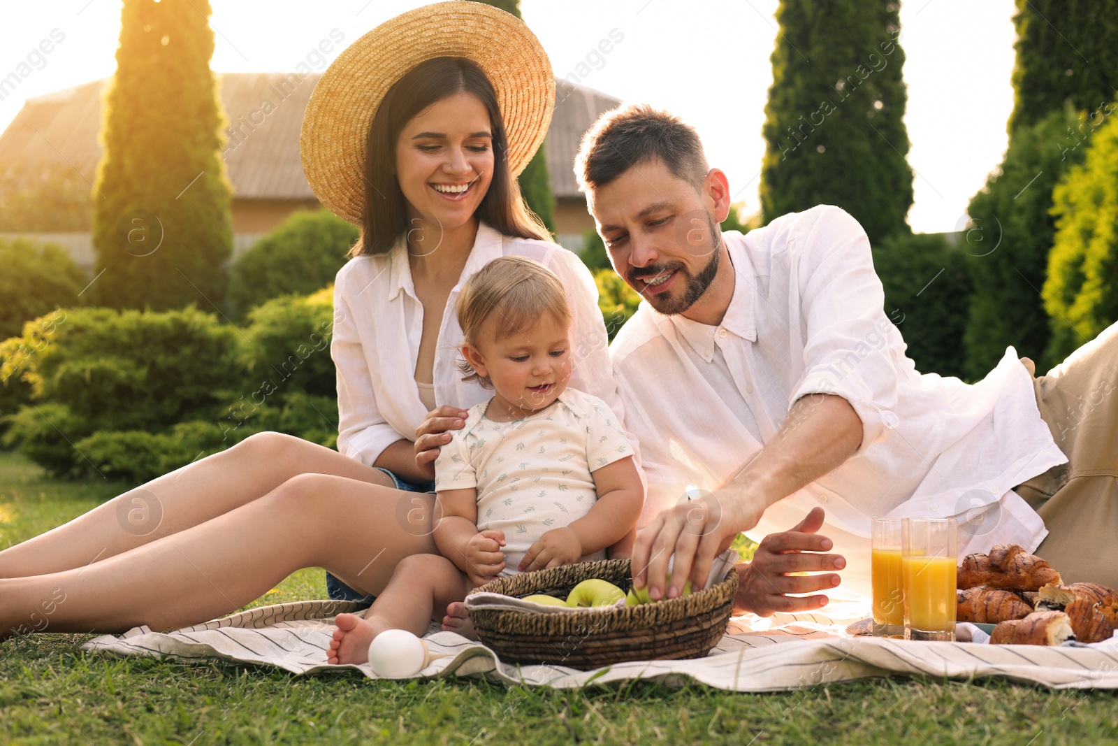 Photo of Happy family having picnic in garden on sunny day