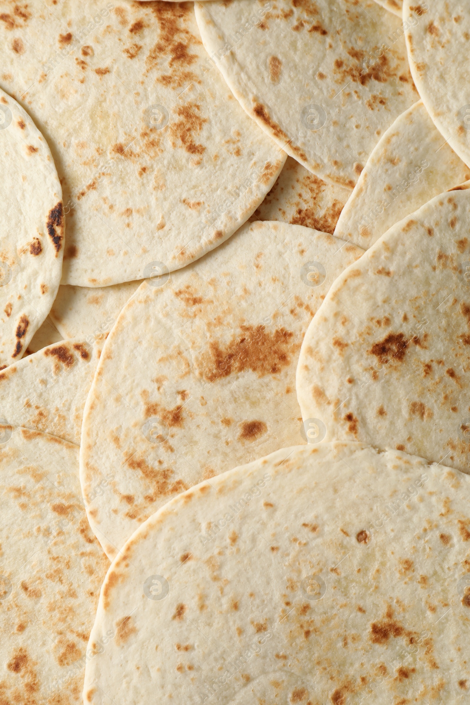 Photo of Many tasty homemade tortillas as background, top view