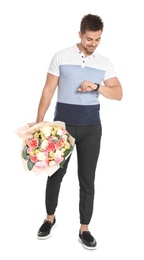 Young handsome man with beautiful flower bouquet on white background