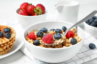 Photo of Tasty breakfast with muesli on white wooden table, closeup