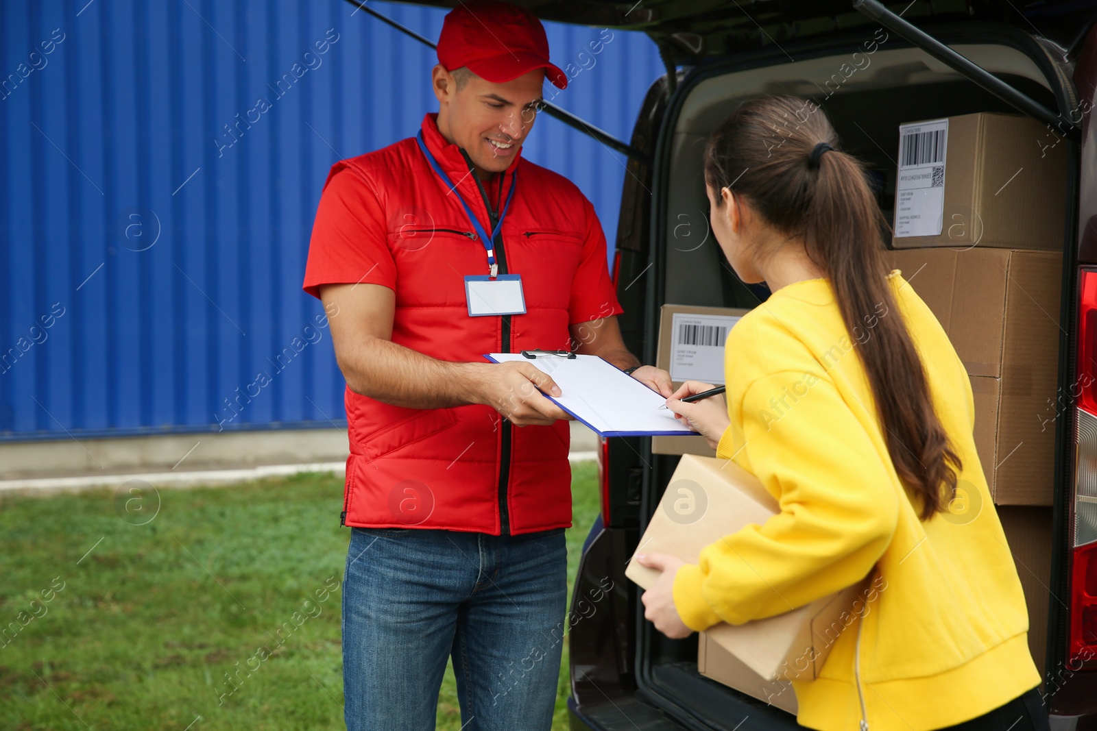 Photo of Courier receiving receipt signature from customer outdoors