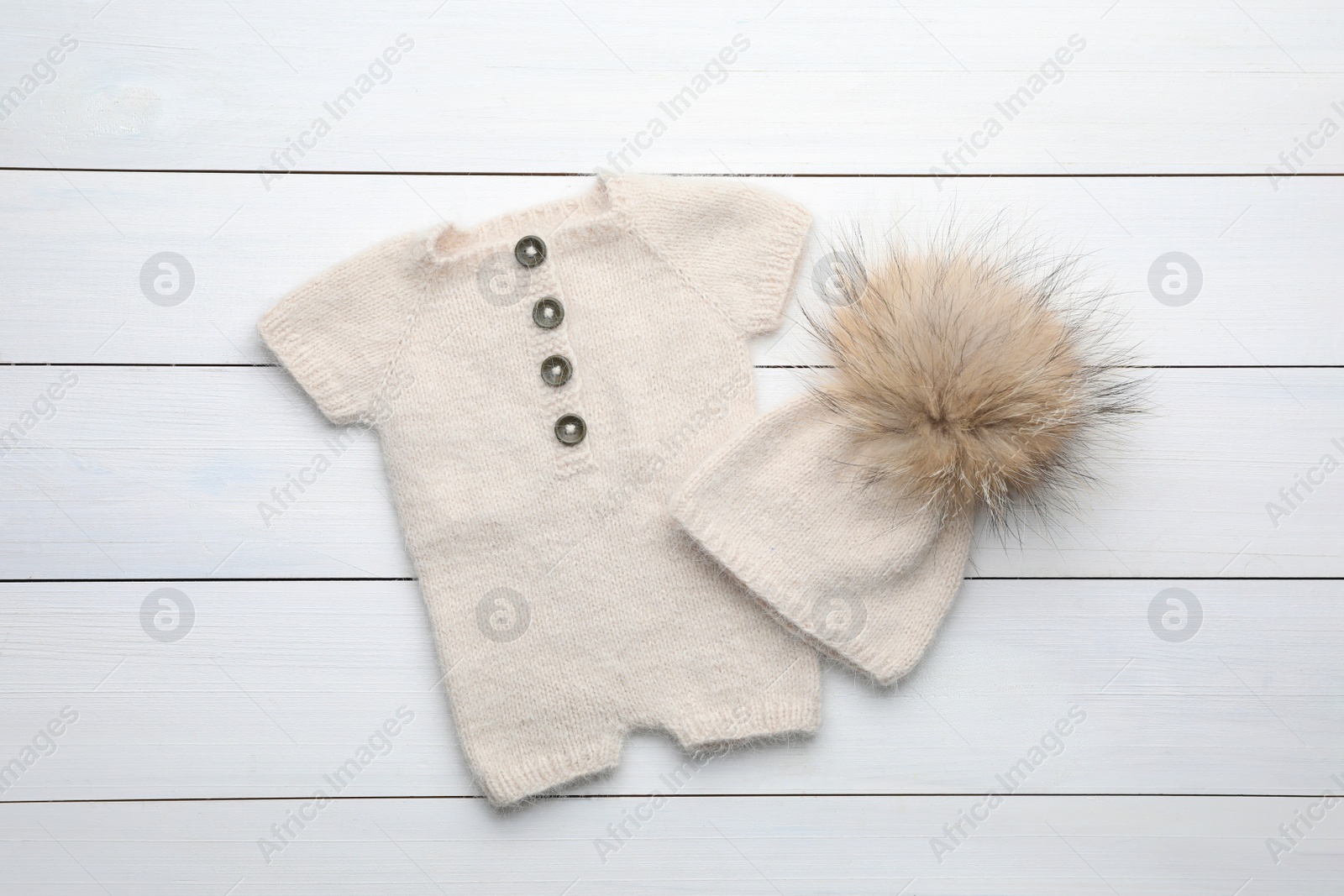 Photo of Stylish child's clothes on white wooden table, flat lay
