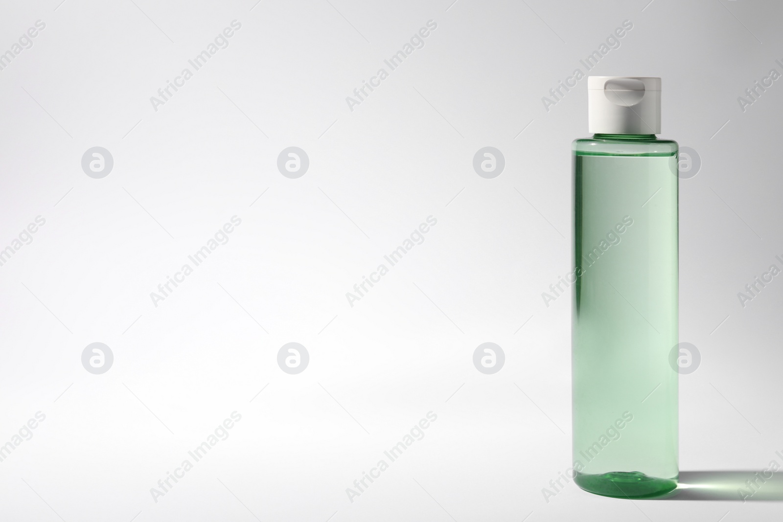 Photo of Bottle of micellar water on white background. Space for text