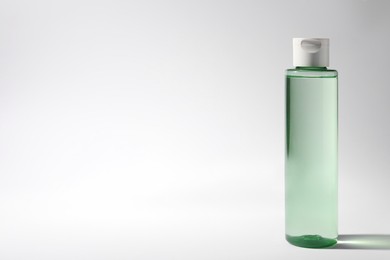 Photo of Bottle of micellar water on white background. Space for text