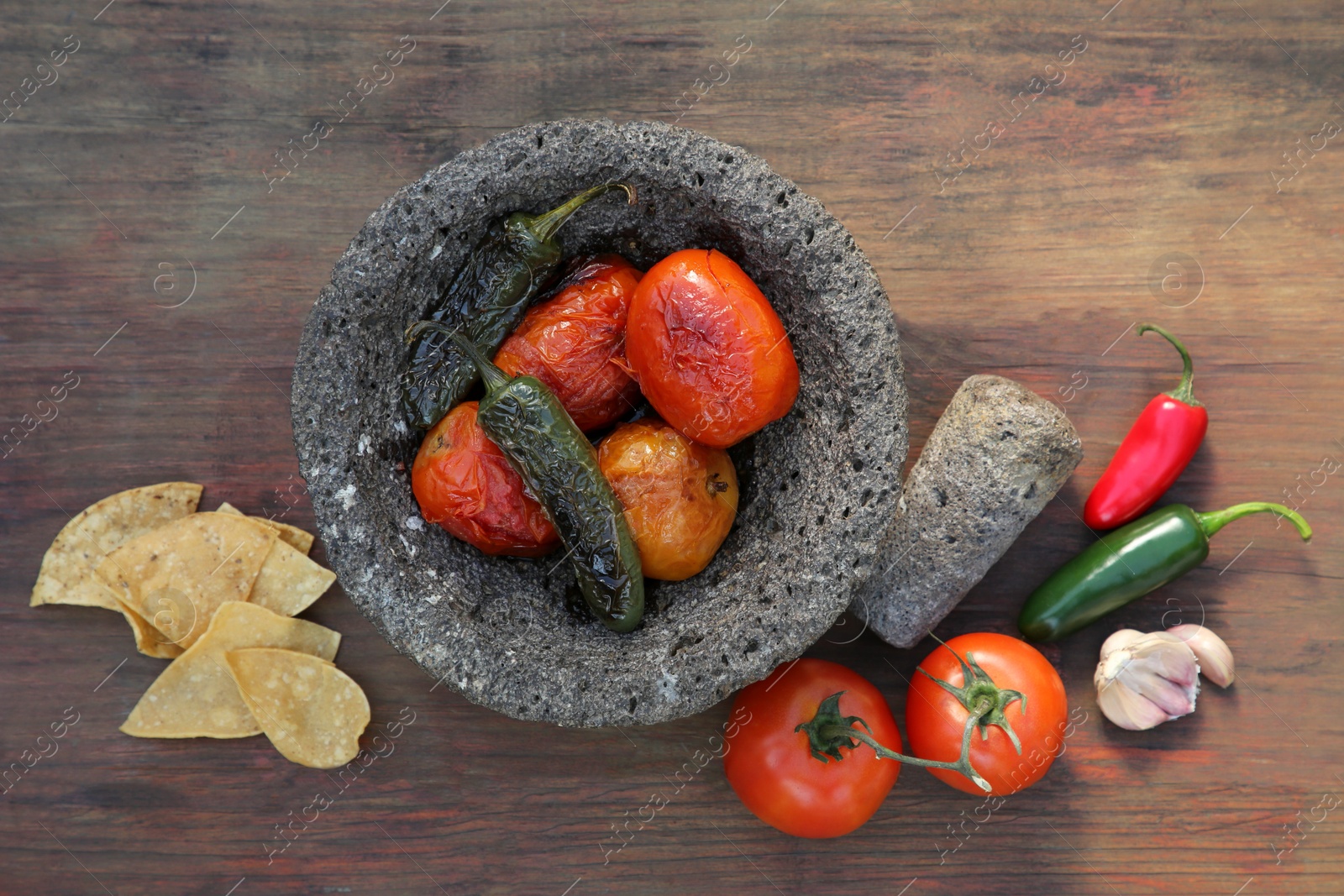 Photo of Ingredients for salsa sauce and tortilla chips on wooden table, flat lay