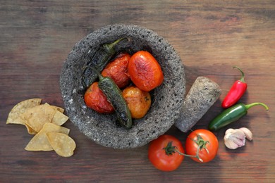 Ingredients for salsa sauce and tortilla chips on wooden table, flat lay
