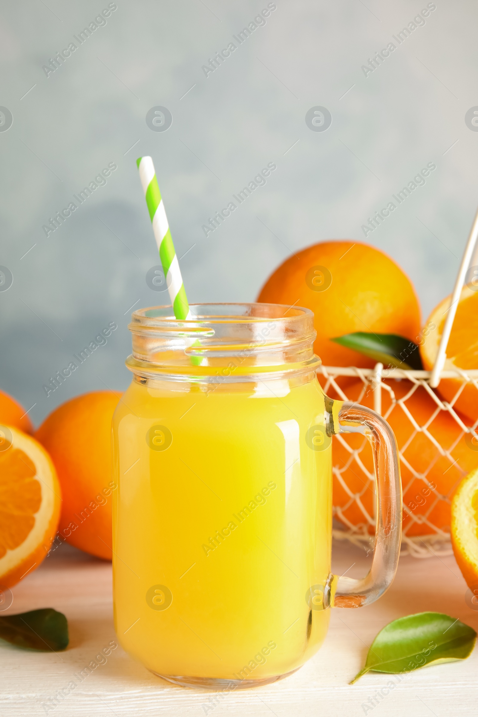 Photo of Composition with orange juice and fresh fruit on table