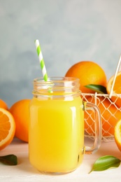 Composition with orange juice and fresh fruit on table