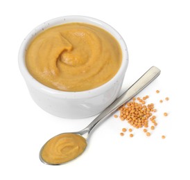 Photo of Fresh tasty mustard sauce in bowl and spoon with dry seeds isolated on white