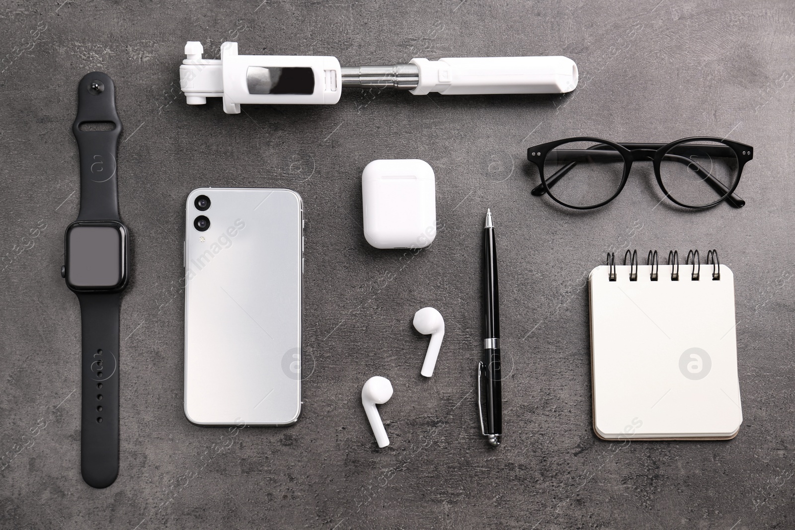Flat lay composition with stylish smart watch on grey stone table Photo of Flat lay composition with stylish smart watch on grey stone table