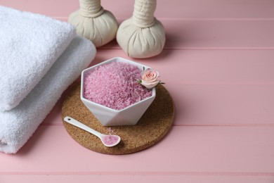 Photo of Composition with sea salt and herbal bags on pink wooden table. Space for text