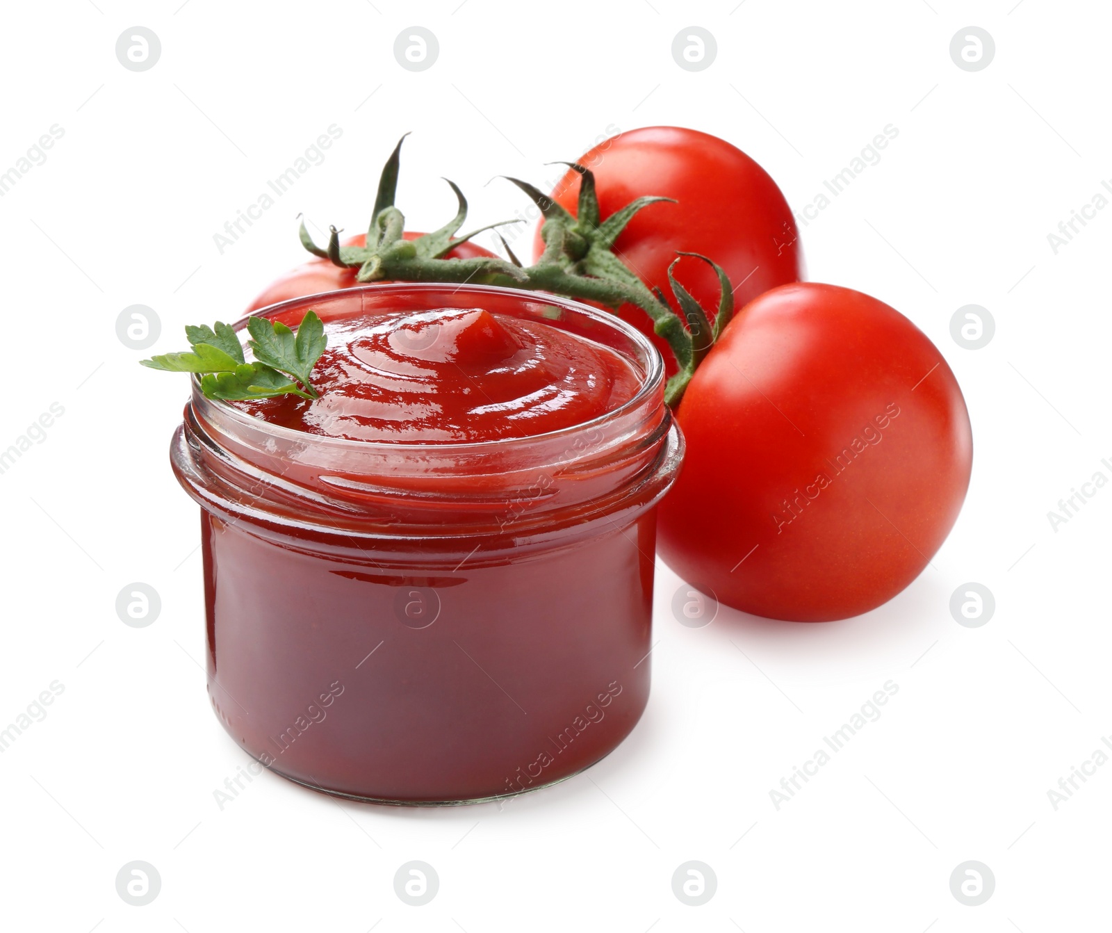 Photo of Tasty ketchup in glass jar and fresh tomatoes isolated on white