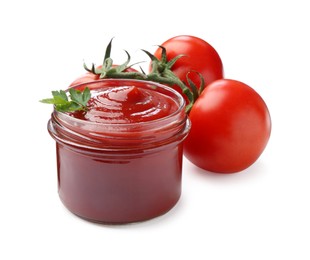 Photo of Tasty ketchup in glass jar and fresh tomatoes isolated on white