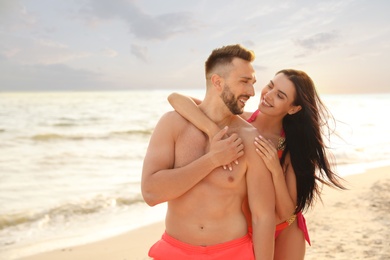 Photo of Happy young couple on beach on sunny day