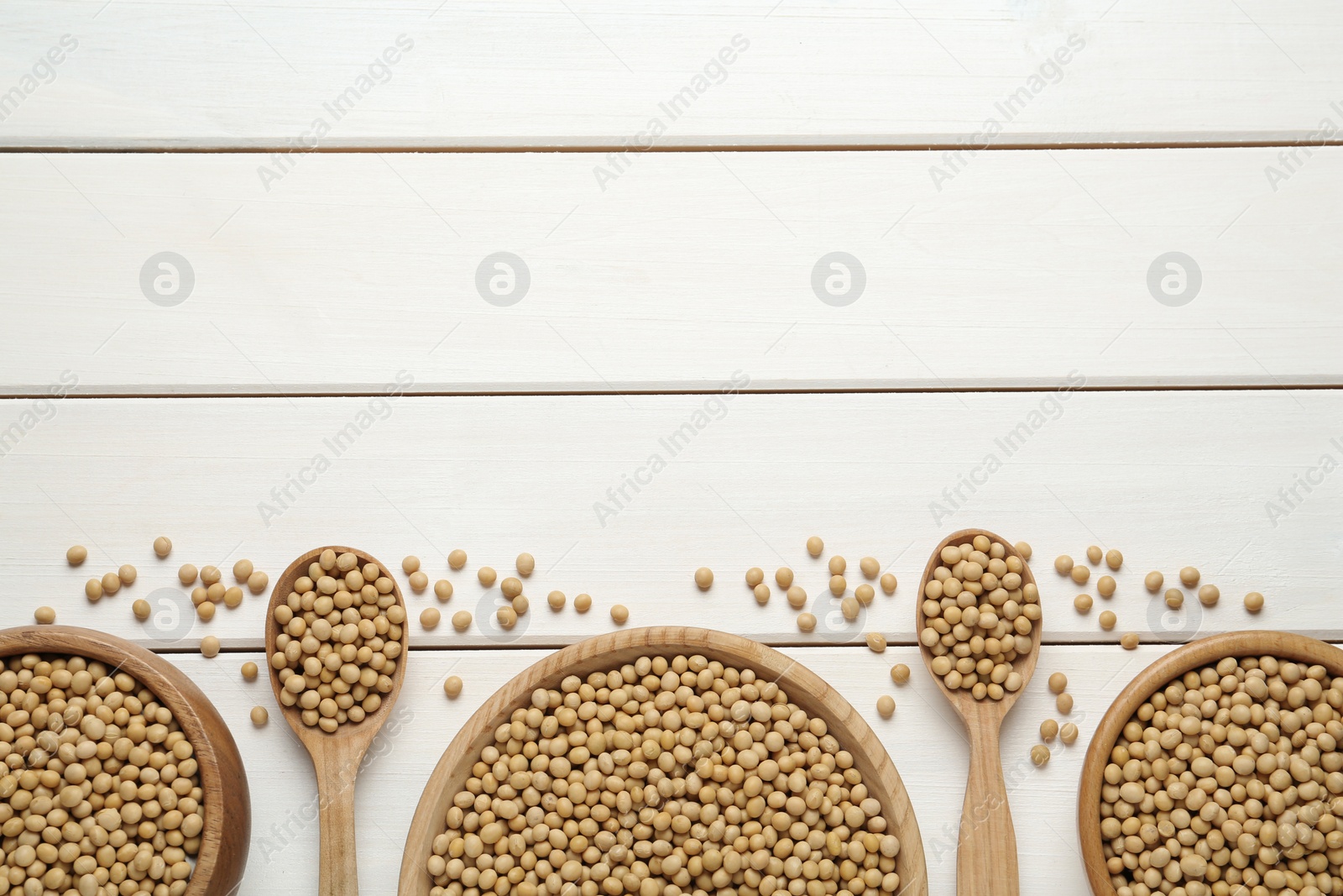Photo of Soy on white wooden table, flat lay. Space for text