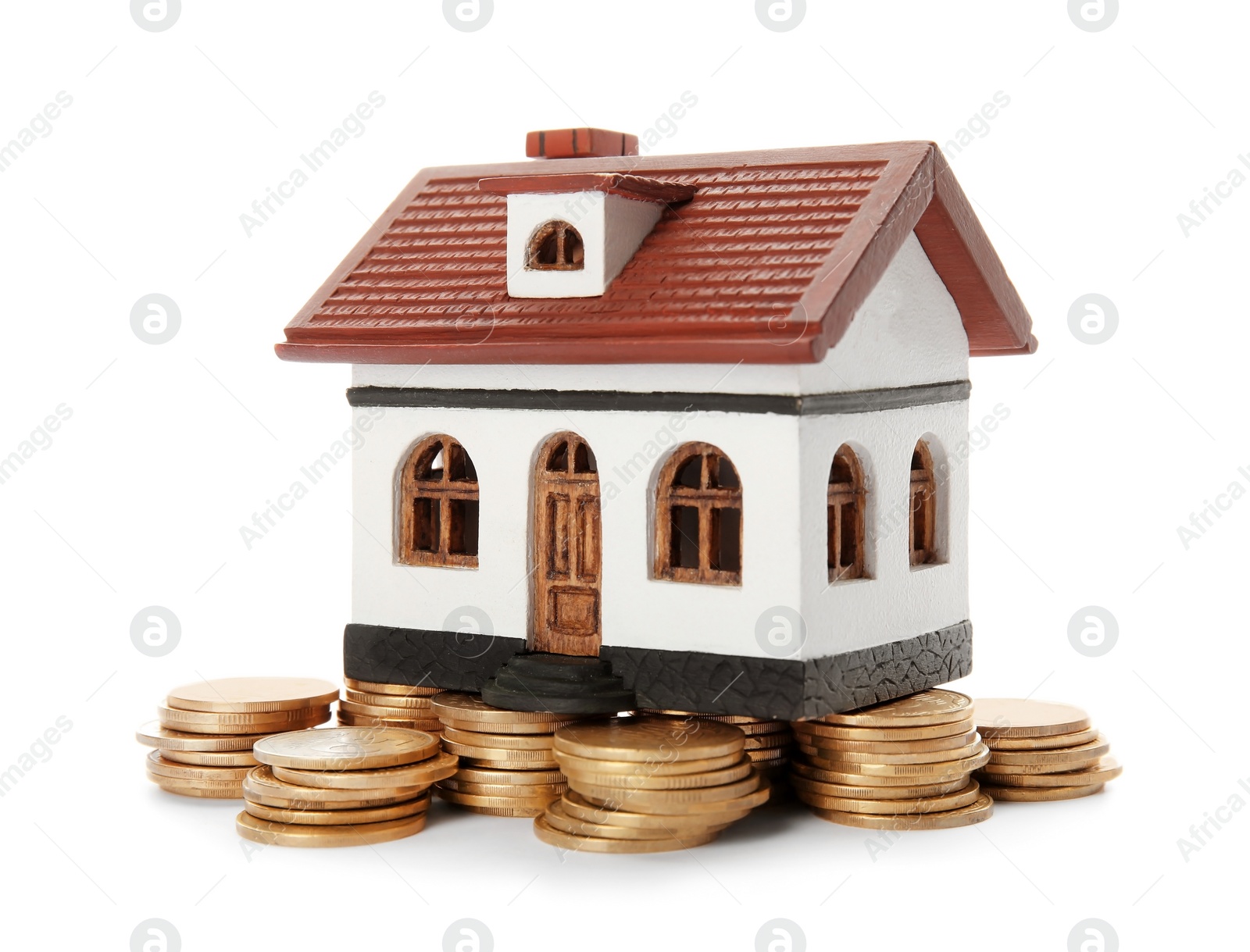 Photo of House model and coins on white background. Heating price concept