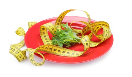 Photo of Measuring tape, plate and lettuce leaf isolated on white. Diet concept