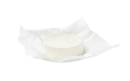 Photo of Tasty brie cheese with wrapper isolated on white