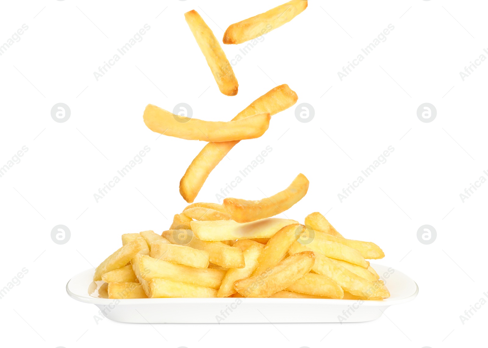 Image of Tasty French fries falling onto plate on white background