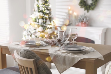 Image of Festive table setting and beautiful Christmas decor in living room. Interior design