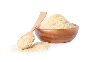 Bowl and spoon with uncooked parboiled rice on white background