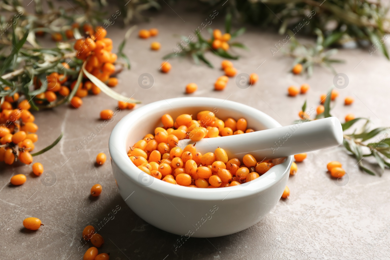 Photo of Ripe sea buckthorn berries on marble table