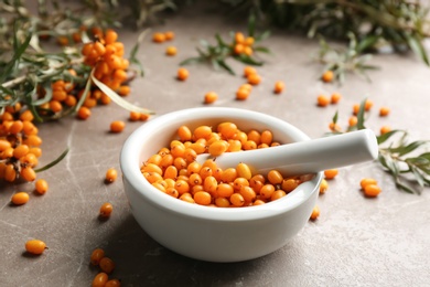 Ripe sea buckthorn berries on marble table