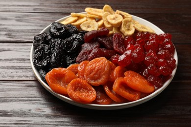 Delicious dried fruits on wooden table, closeup