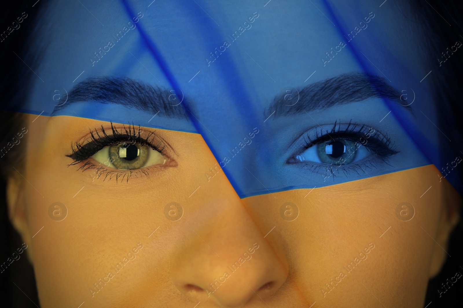 Image of Double exposure of Ukrainian national flag and young woman, closeup view