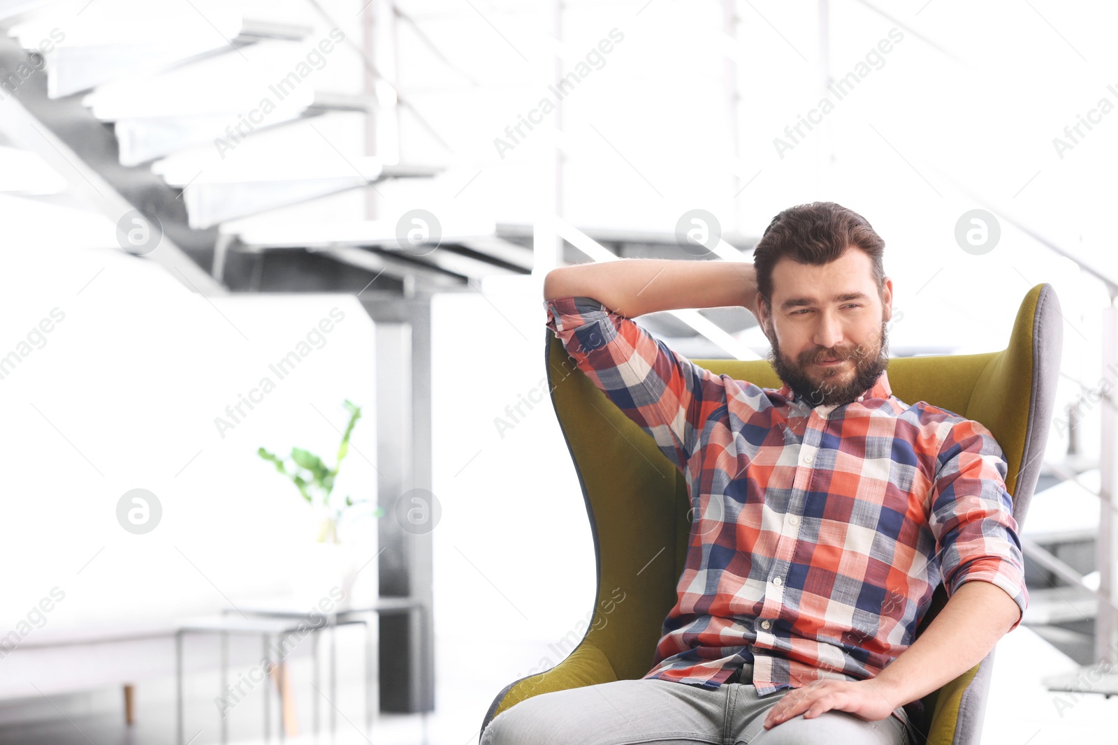 Photo of Portrait of confident mature man in armchair