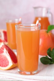 Photo of Tasty freshly made grapefruit juice on towel